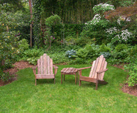 Close up of a small seating area in a large backyard garden