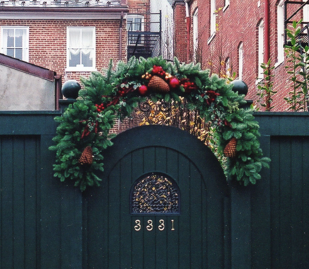Faux fruit and greenery over a garden gate.
 : Holiday Decorating, Faux Plant and Flower Installations : CITYSCAPES® Landscaping LLC