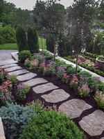 Flagstone slabs create a less formal walkway through the perennial beds.