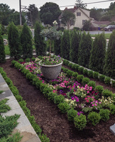 This terrace has a formal parterre for seasonal annuals and is bordered by English boxwood.