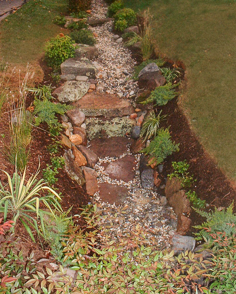A dry stream bed is visually appealing and solves the mowing issue while providing drainage. : Suburban Gardens : CITYSCAPES® Landscaping LLC