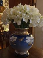 Faux amaryllis stems in an antique Chinese vase.
