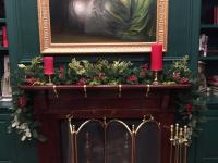 Holiday faux greenery on a mantel.