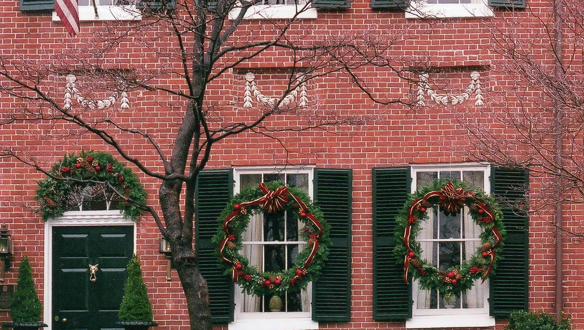 Faux evergreen wreaths decorated with faux berries and colorful ribbons.
 : Holiday Decorating, Faux Plant and Flower Installations : CITYSCAPES® Landscaping LLC