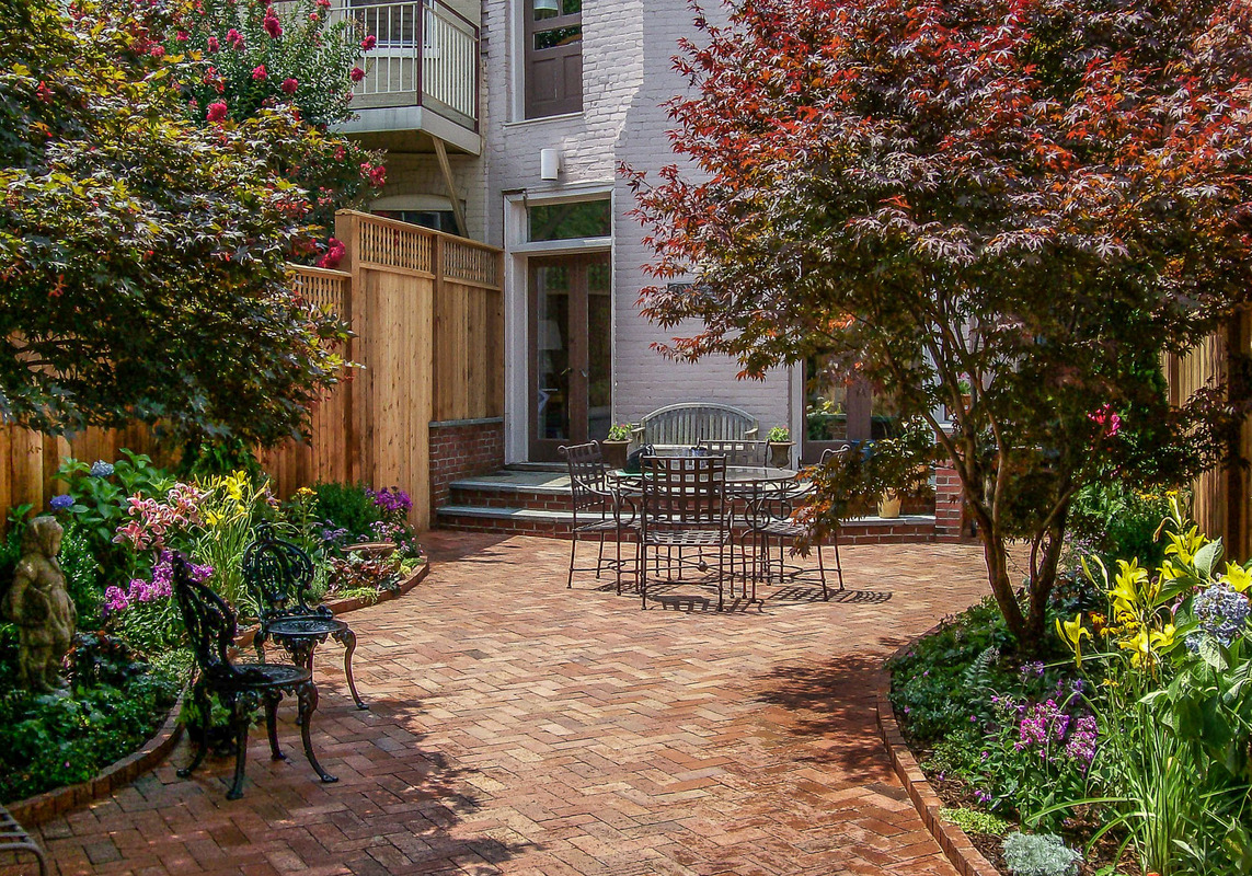 A patio garden with curving planting beds softens the rectangular back yard of this Georgetown home. : Georgetown, Capitol Hill, and NW Gardens : CITYSCAPES® Landscaping LLC