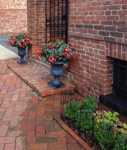 Cast iron planters are a welcoming addition to an all brick entrance. : Front Gardens : CITYSCAPES® Landscaping Inc.