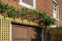 Garden structures like this "eye brow" pergola creates visual elevation and interest.