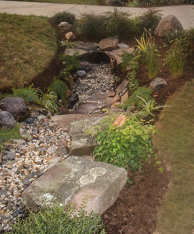 A dry stream bed transforms a grassy culvert and provides drainage. : Garden Details : CITYSCAPES® Landscaping LLC