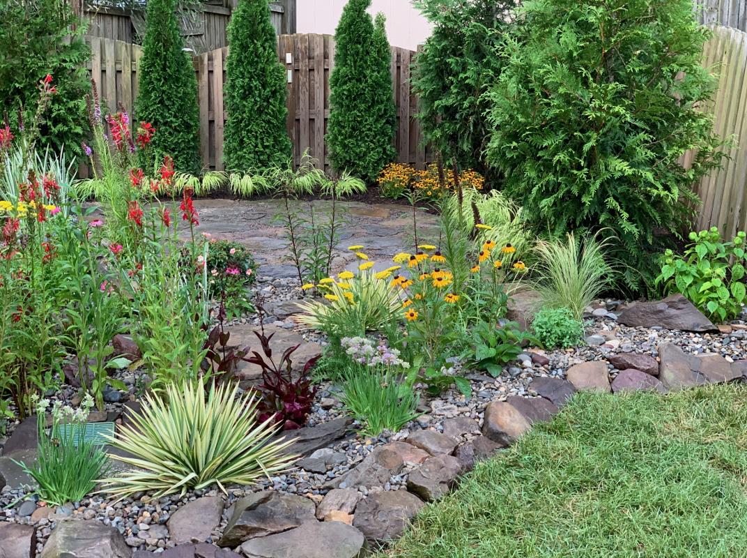 Various size river rocks give textural contrast and mimics nature. : Suburban Gardens : CITYSCAPES® Landscaping LLC